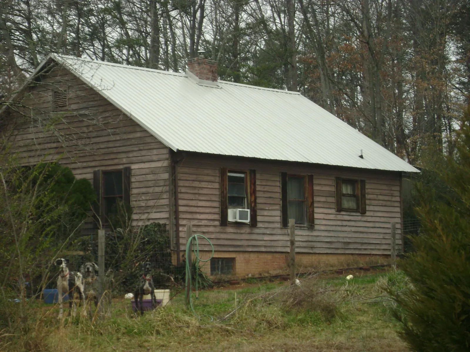 White metal roof on an old wood sided farmhouse, from a Metal Roof Installation job in Poughkeepsie